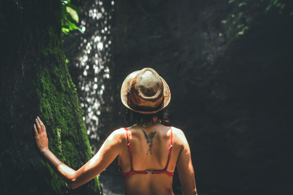 Femme portant un chapeau qui regarde une cascade
